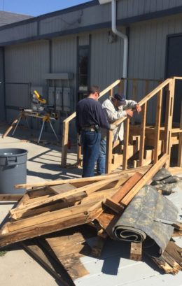 image of airport staff rebuilding the stairs for the temporary passenger holding facility