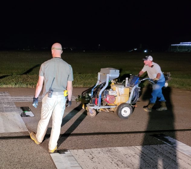 image of airport ops crew completing runway painting during overnight project.