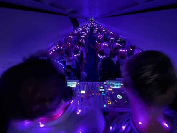image of cockpit with blacklights as a dj spins rave music